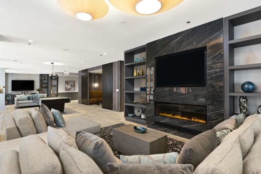 a living room with a large couch and a fireplace